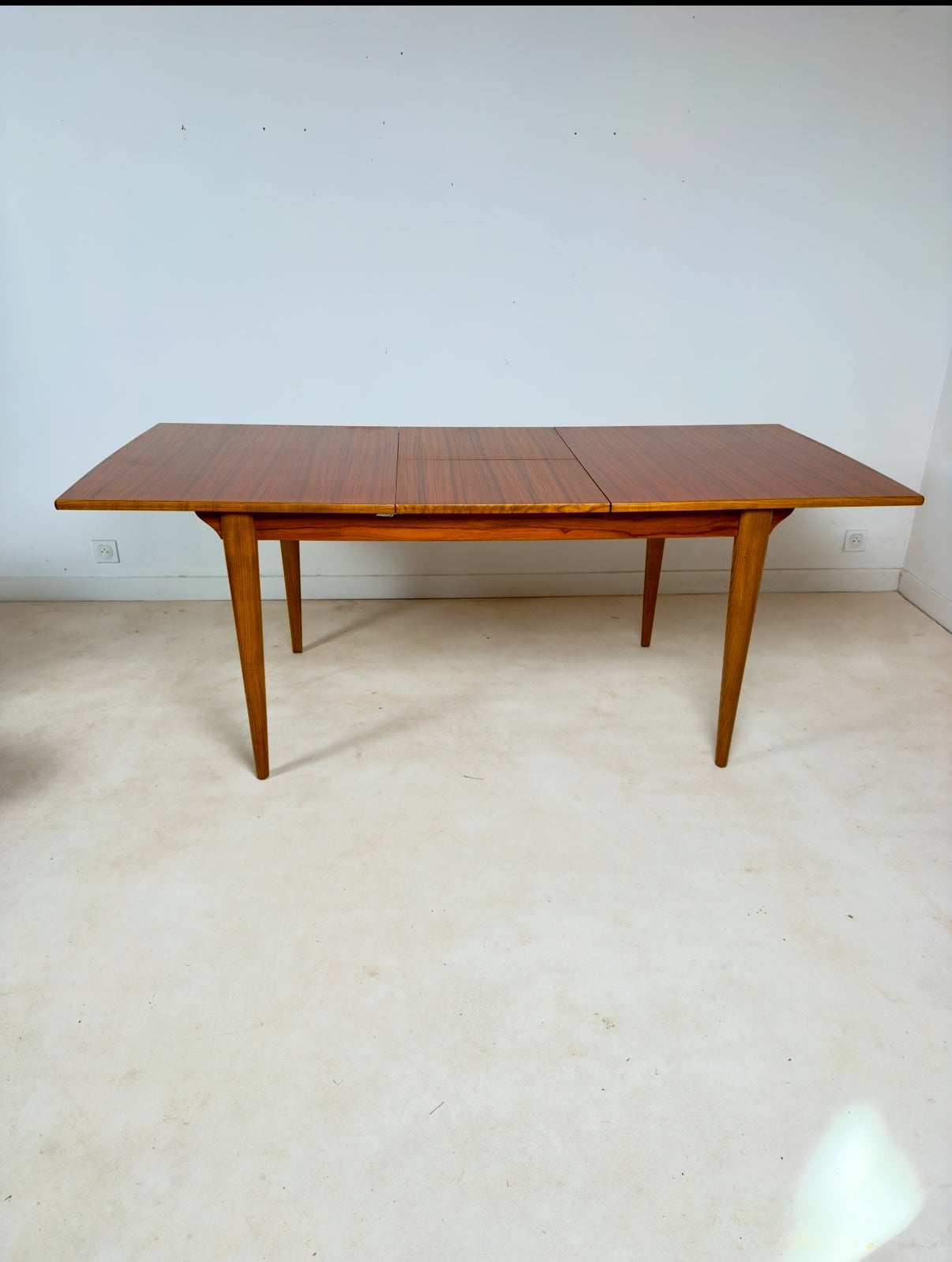 Table de salle à manger de style scandinave à rallonges intégrées.